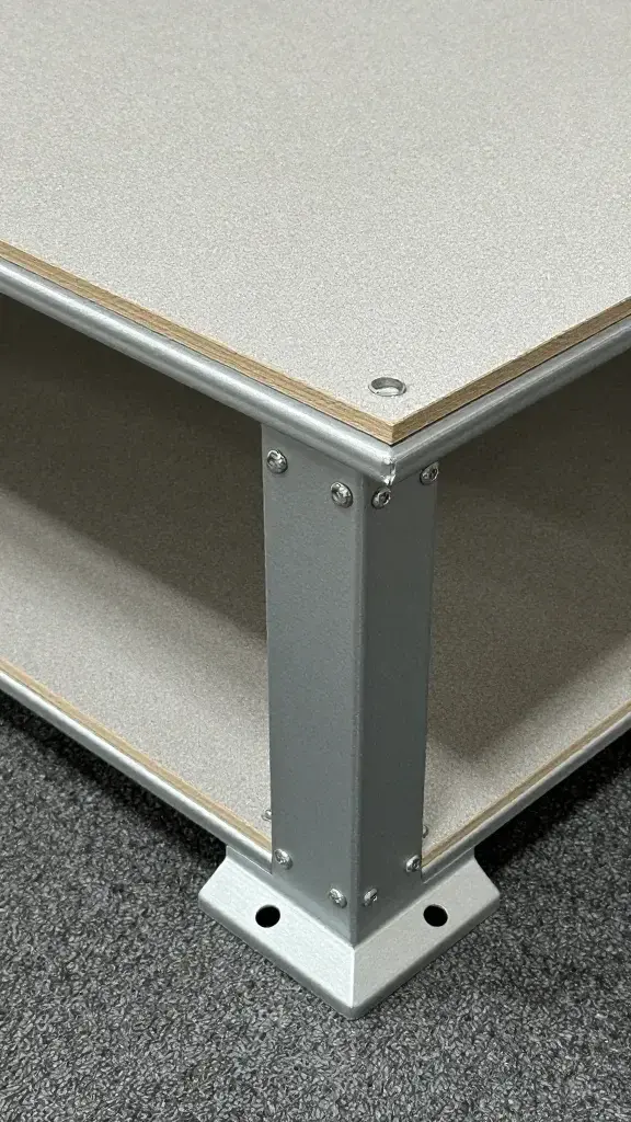 Close-up: composite shelf reinforcement brackets and carpet tiles