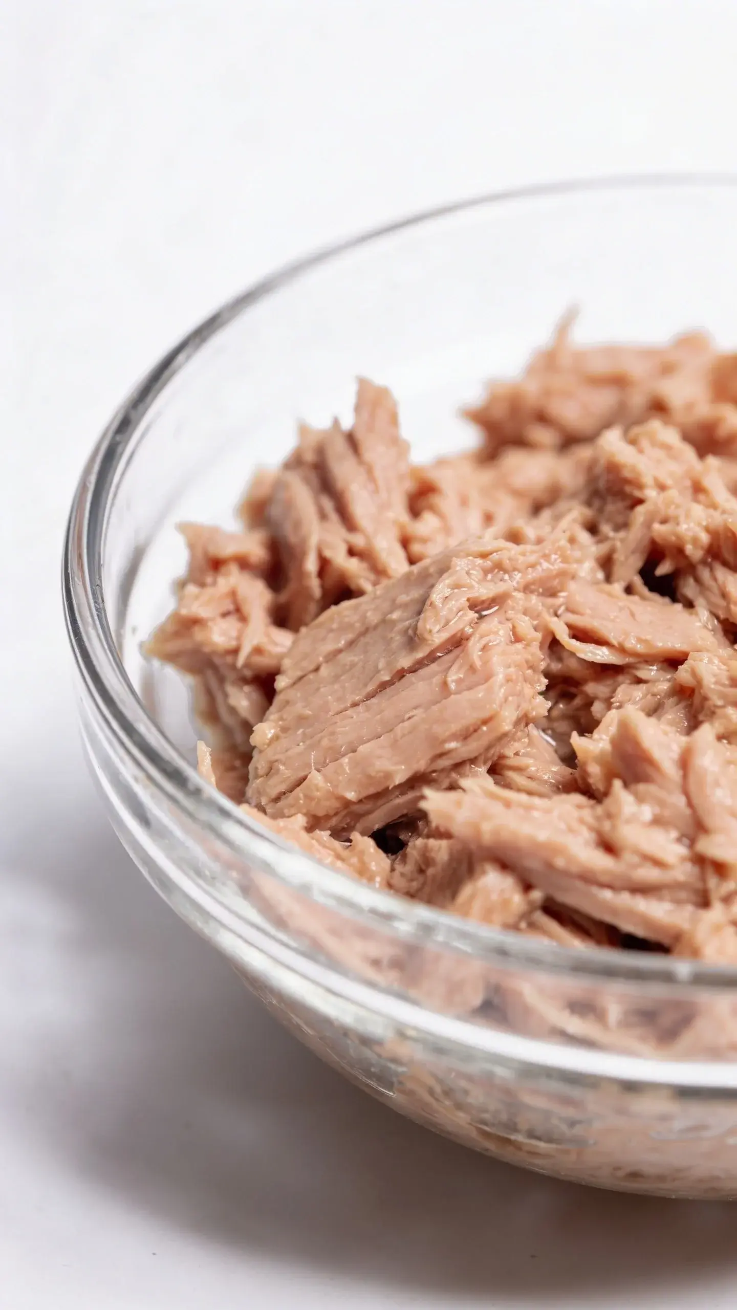 canned tuna in water, drained, in glass bowl